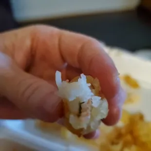 a hand holding a piece of food