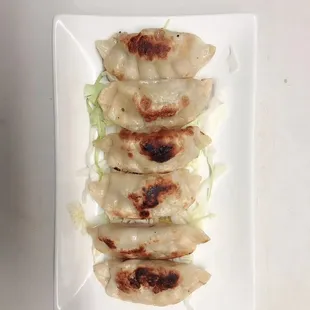 a plate of dumplings on a white plate