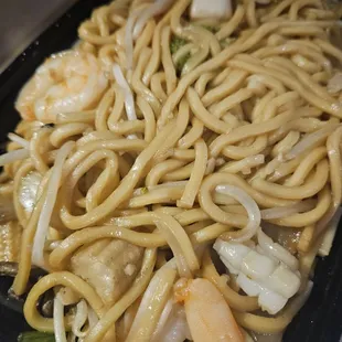 shrimp and noodles in a black container