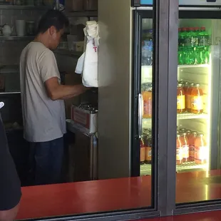 a man standing in front of a refrigerator