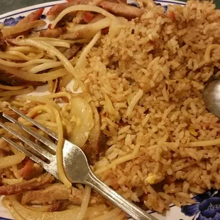 a plate of rice, meat and vegetables