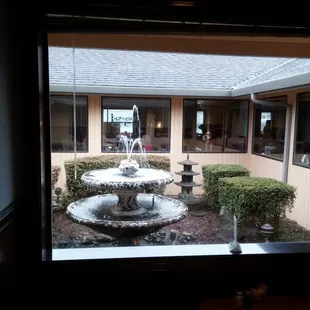 Open garden water fountain in the center of the building.