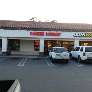 two cars parked in front of a restaurant
