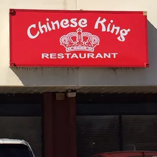 two cars parked in front of a restaurant
