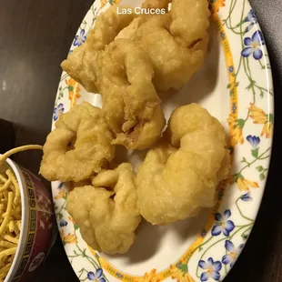 a plate of fried shrimp and noodles