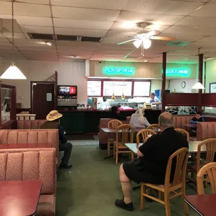 people sitting at tables in a restaurant