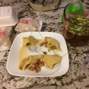 a plate of dumplings and a cup of tea