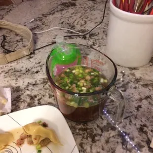 a plate of noodles and a cup of soup