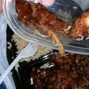 a person holding a fork and a plastic container of food