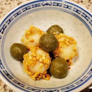 Dessert dumplings with chopped candied squash filling and rolled in crushed peanuts (after)