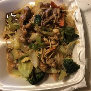 a plate of noodles with meat and vegetables