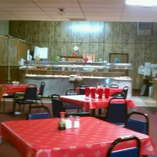 tables and chairs with red tablecloths