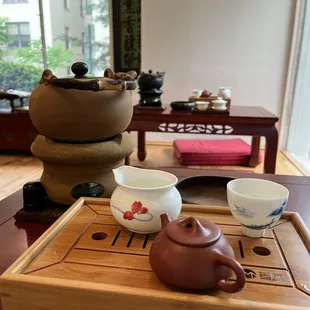 a teapot and tea cups on a wooden tray