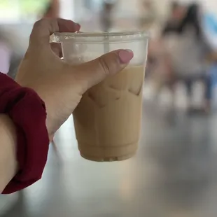 a person holding a cup of coffee