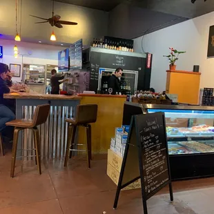 a woman sitting at a counter in a restaurant