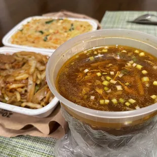 a bowl of soup and a plate of noodles