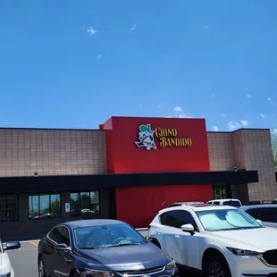 cars parked in front of a restaurant