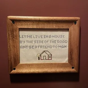a cross stitch picture of a house