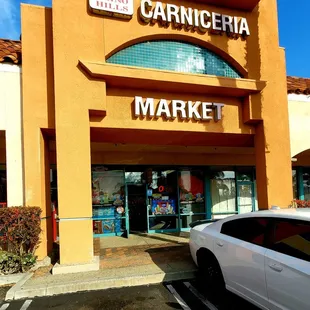 a white car parked in front of the store
