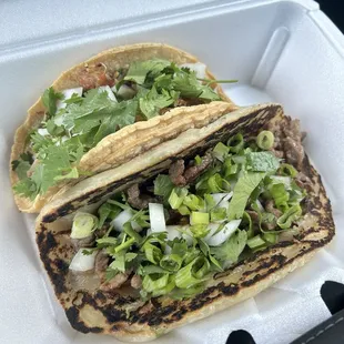 Amazing tacos! Scallion pancake on lower right with Mongolian beef and upper left is corn shell with pork.