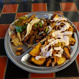 Kimchi fries with pork belly and chicken adobo tacos.