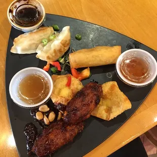 DIM SUM PLATTER  two cream cheese puffs, two wings, two potstickers, and one Thai spring roll