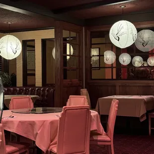  dining room with pink chairs and tables