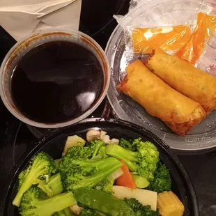 Steamed veggies, brown sauce on the side, beef spring rolls, white rice.
