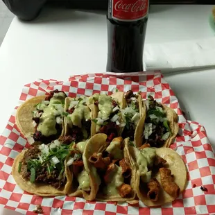 a plate of tacos and a coke