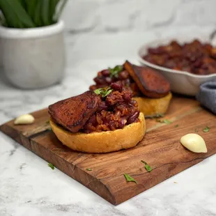 a wooden cutting board with a sandwich on it