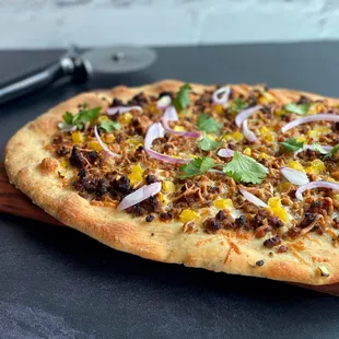a pizza on a cutting board