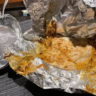 Quesadilla shoved into a burrito bowl container with no sides