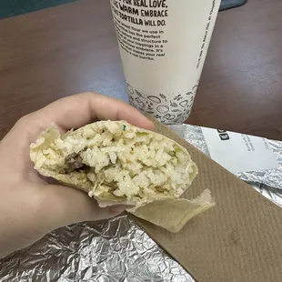a hand holding a burrito
