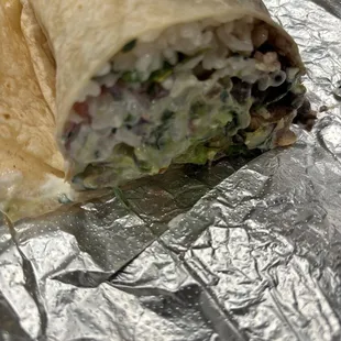 Small burrito cut in half. This side has just rice. The other side has the meat