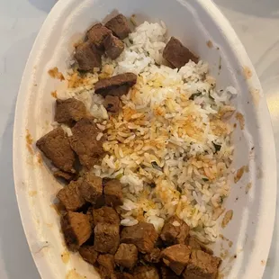 Double steak, double rice from an online order. Looks half eaten, but it was just opened moments before.