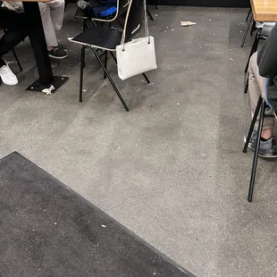 Trash, food in the floor. Dirty tables.