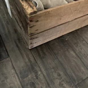 a wooden box with a blanket on top