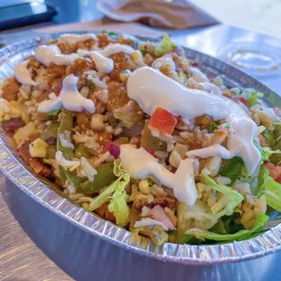 Build your own bowl with chicken, fajitas, corn, lettuce, cheese, tomatoes, pinto beans, brown rice, sour cream