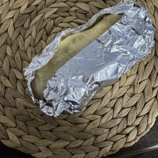 a hot dog wrapped in tin foil