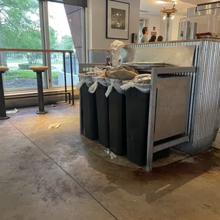 Overflowing trash cans... trash on floor