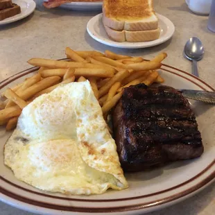 Steak and Eggs with fries as a hash brown substitute. Good size.