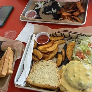 two trays of food on a red table