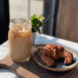 Iced vanilla latte with plain croissant.