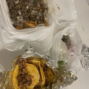 Carne Asada fries and Al pastor tacos