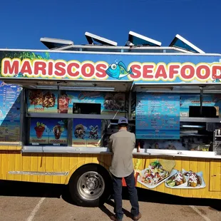 two people ordering food from a food truck