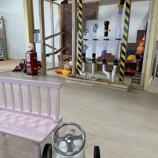 a pink toy car and a pink bench