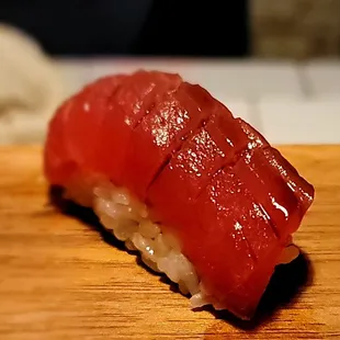 a piece of sushi on a cutting board