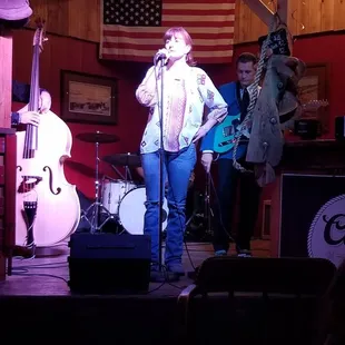 a woman singing on stage