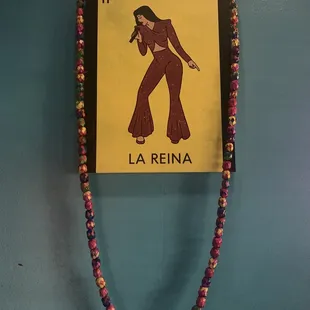 a picture of a woman in a brown dress and a necklace with