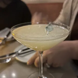a close up of a cocktail in a coupe glass